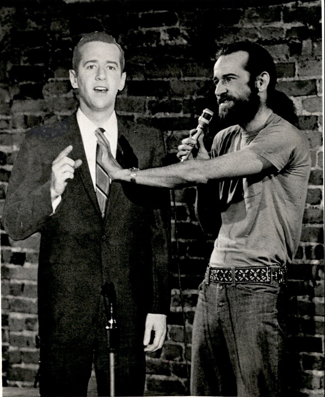 Carlin with a cardboard cutout of himself as he looked in the 1960s. 